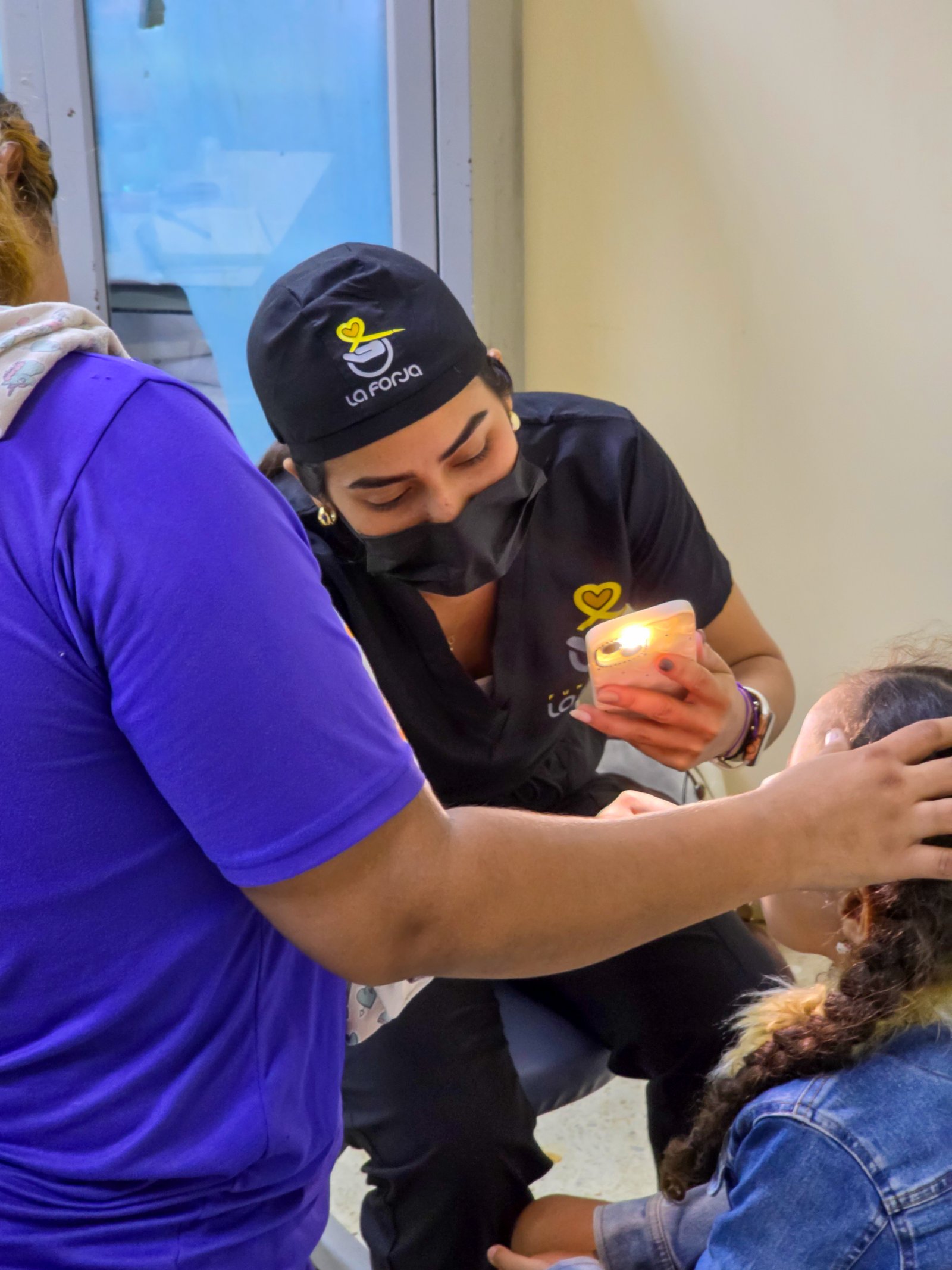 La Forja Foundation doctor performing a medical check-up on a young girl during the Consejo de Ciruma health drive.